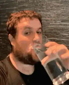 Man spills water drinking