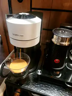 Nespresso machine pouring coffee