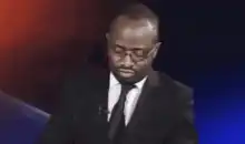 Man in suit looking down