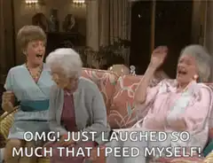 Three women laughing hysterically on a couch
