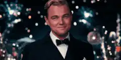 Leonardo DiCaprio toasting with a smile
