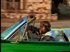 CJ driving a green convertible