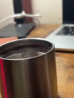 Steam rising from a metal cup