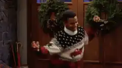 George Jefferson dancing in Christmas sweater