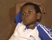 Kid on couch looking bored and annoyed