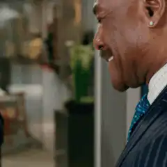 Eddie Murphy laughing and covering face