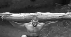Man lifting a heavy log