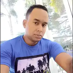 Man in blue shirt looking at camera