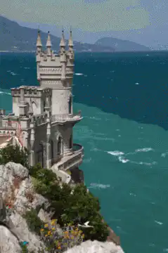 Seagull flies past Swallow's Nest