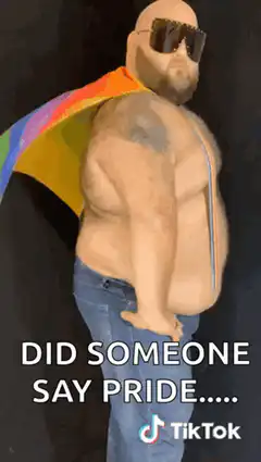 Bald man with rainbow cape says pride