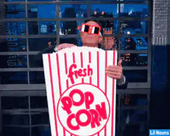 man eating popcorn with sunglasses