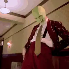 The Mask hits himself with a mallet