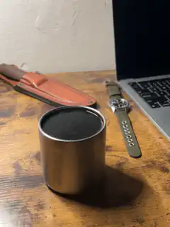 cylindrical speaker vibrating on table