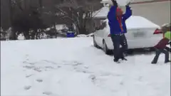 Person throws snowball at child