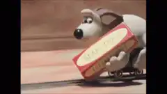 Gromit on a train with a cheese box