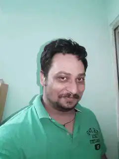 Man in green shirt smirking