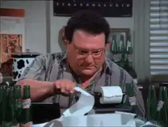 Man pulls receipt from cash register