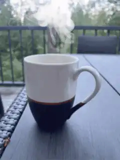 Steaming mug on balcony