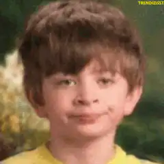 Young boy smirking and blinking