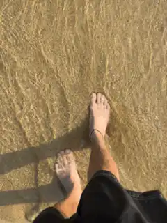 First person view walking barefoot on beach