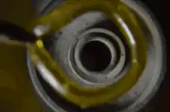 Pouring oil into a metal container