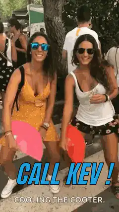 Two women fanning themselves with 'Call Kev'