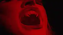 Vampire screaming in red light