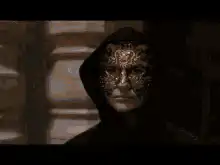 Venetian masked figures in dark hood