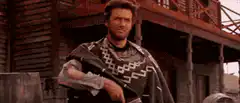 Clint Eastwood puts on poncho