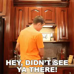 Man turns around surprised in kitchen