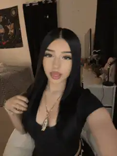 Woman posing and lip-syncing in bedroom