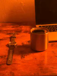 watch and coffee cup on desk