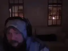 Bearded man in hoodie looking around