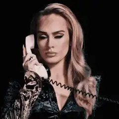 Adele holding phone says hello