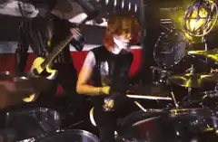 Red-haired drummer playing on stage