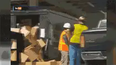 Worker drops boxes into truck