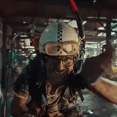 Man in helmet grinning excitedly