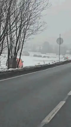 orange van stuck in snow