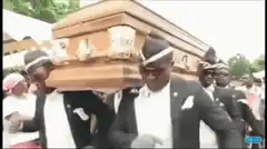 Men dancing while carrying a coffin
