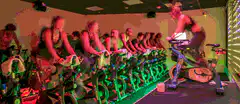 people cycling in a spin class