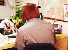 Dwight Schrute turns around with a wig