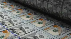 Roll of hundred dollar bills unrolling