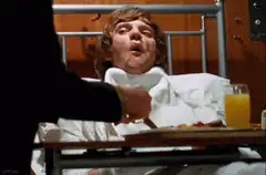 Alex in hospital bed being fed