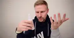Man sprays hand sanitizer and reacts