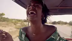 woman laughing in a moving vehicle
