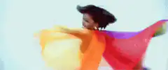 Whitney Houston dancing with rainbow cape