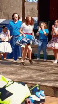 Man in blue shirt dancing on stage