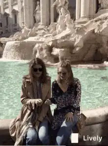 Two women posing at Trevi Fountain