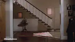 Woman slips on rug at bottom of stairs