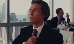 Gordon Gekko adjusting his tie